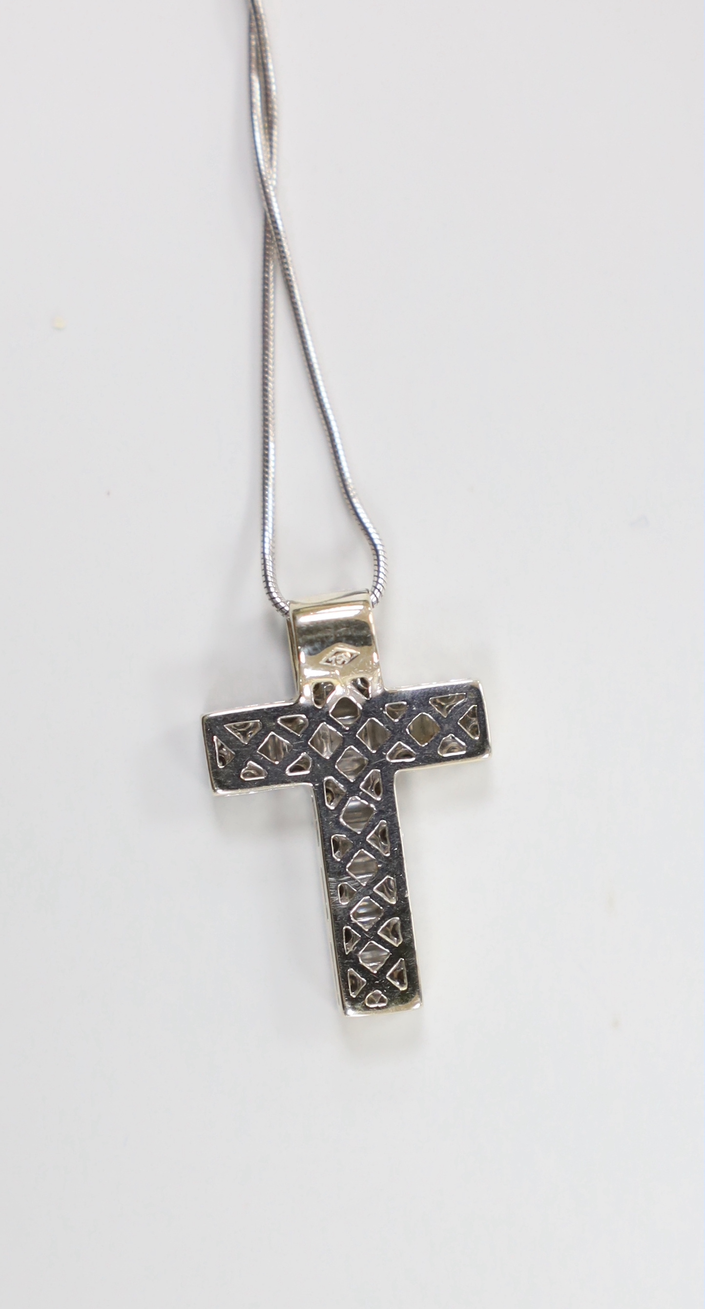 A modern 750 white metal, baguette and round cut diamond cluster set cross pendant, 23mm, gross 3.1 grams, on a 375 white metal fine chain, 46cm, 2.6 grams.